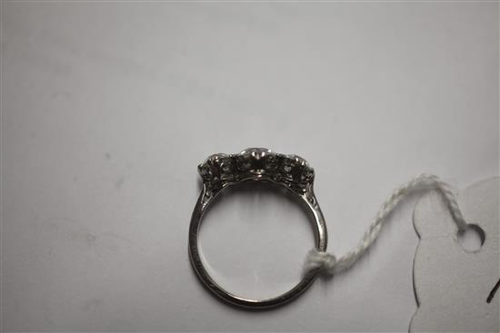 A mid 20th century platinum? and three stone diamond ring, size O.